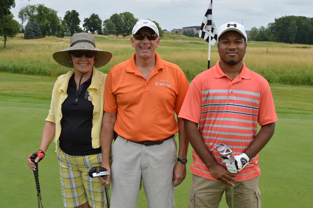 A golf team of 3 alumni.